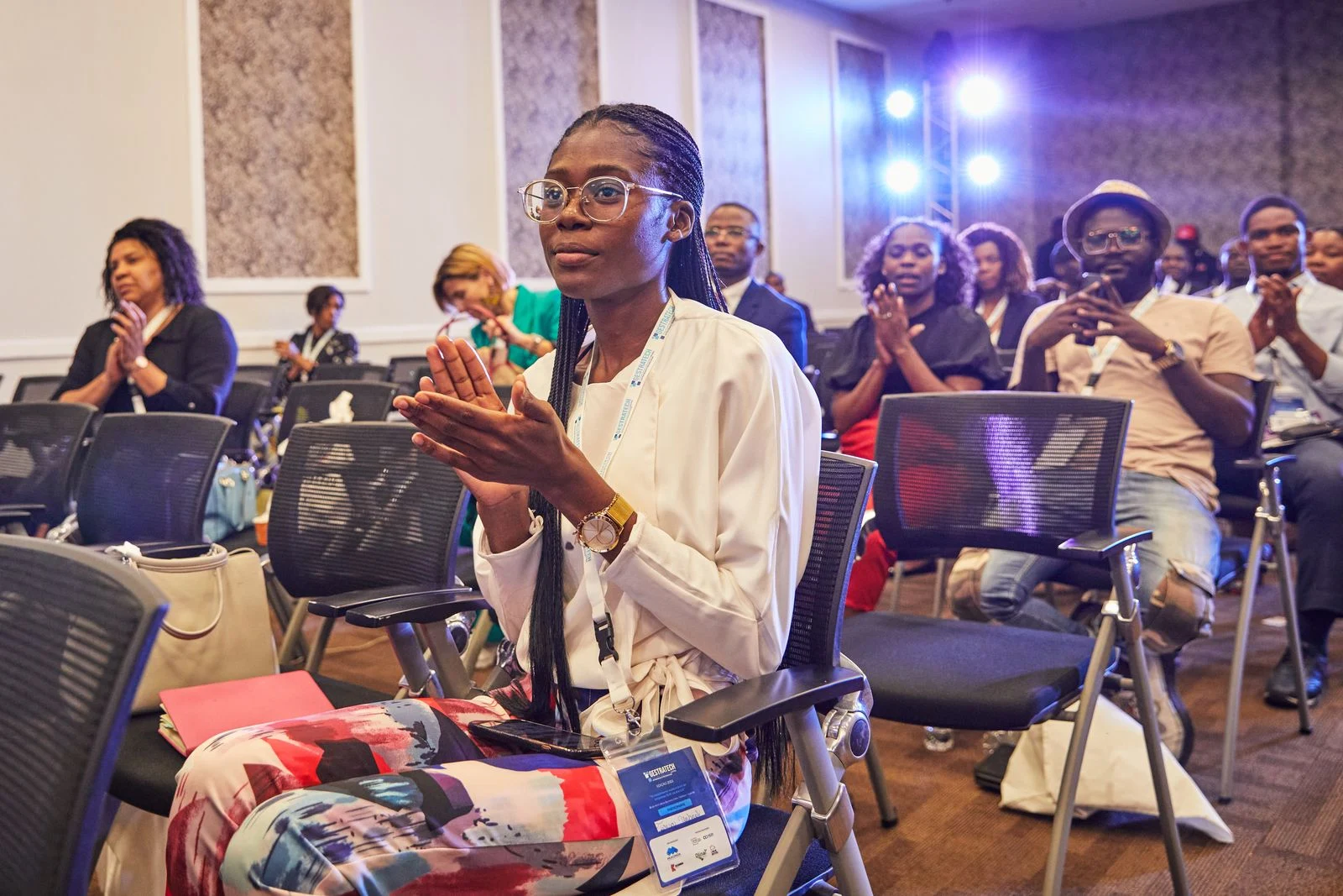 Conference audience applauding during a professional event; illustrative stock photography