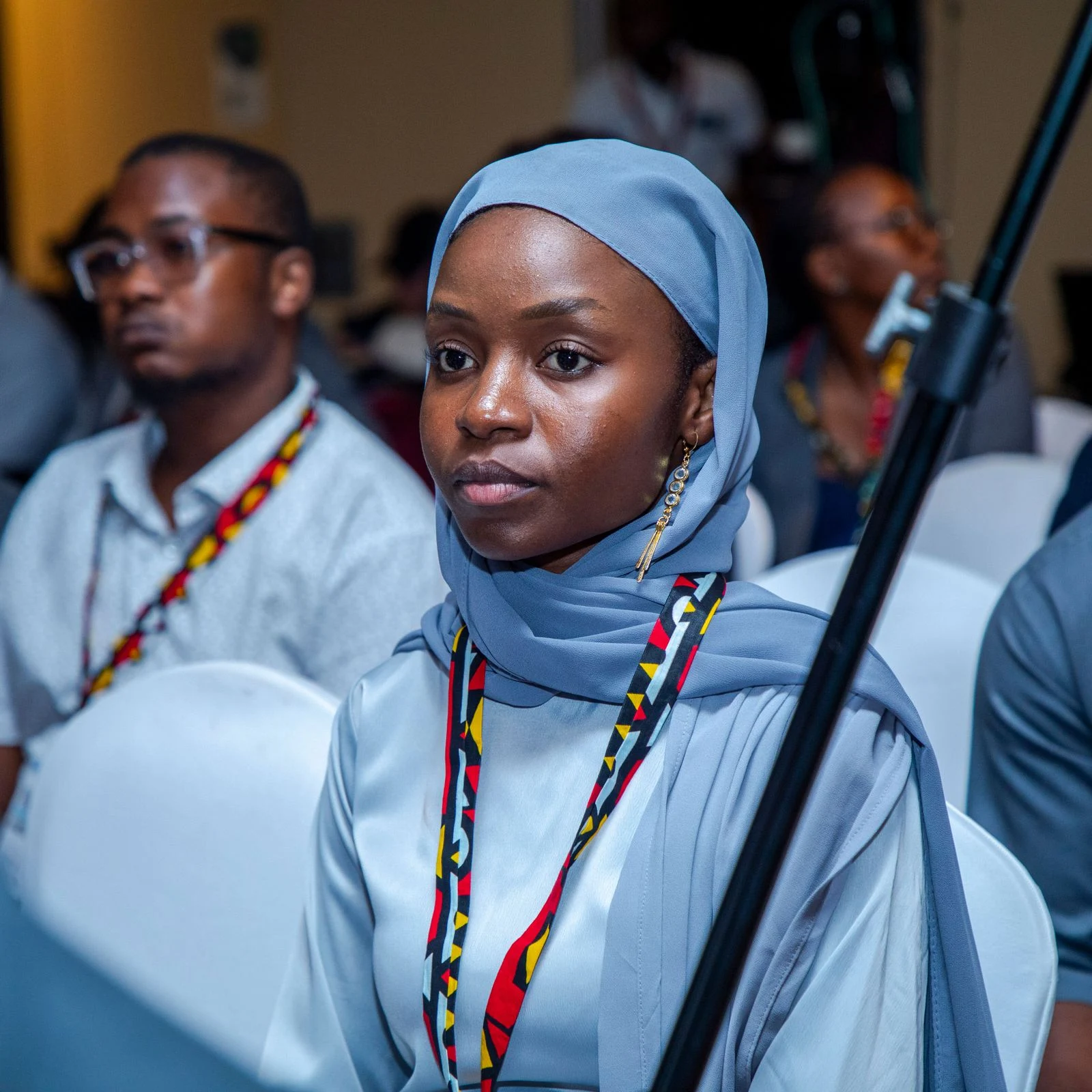 An attentive audience member at a conference; illustrative stock photography