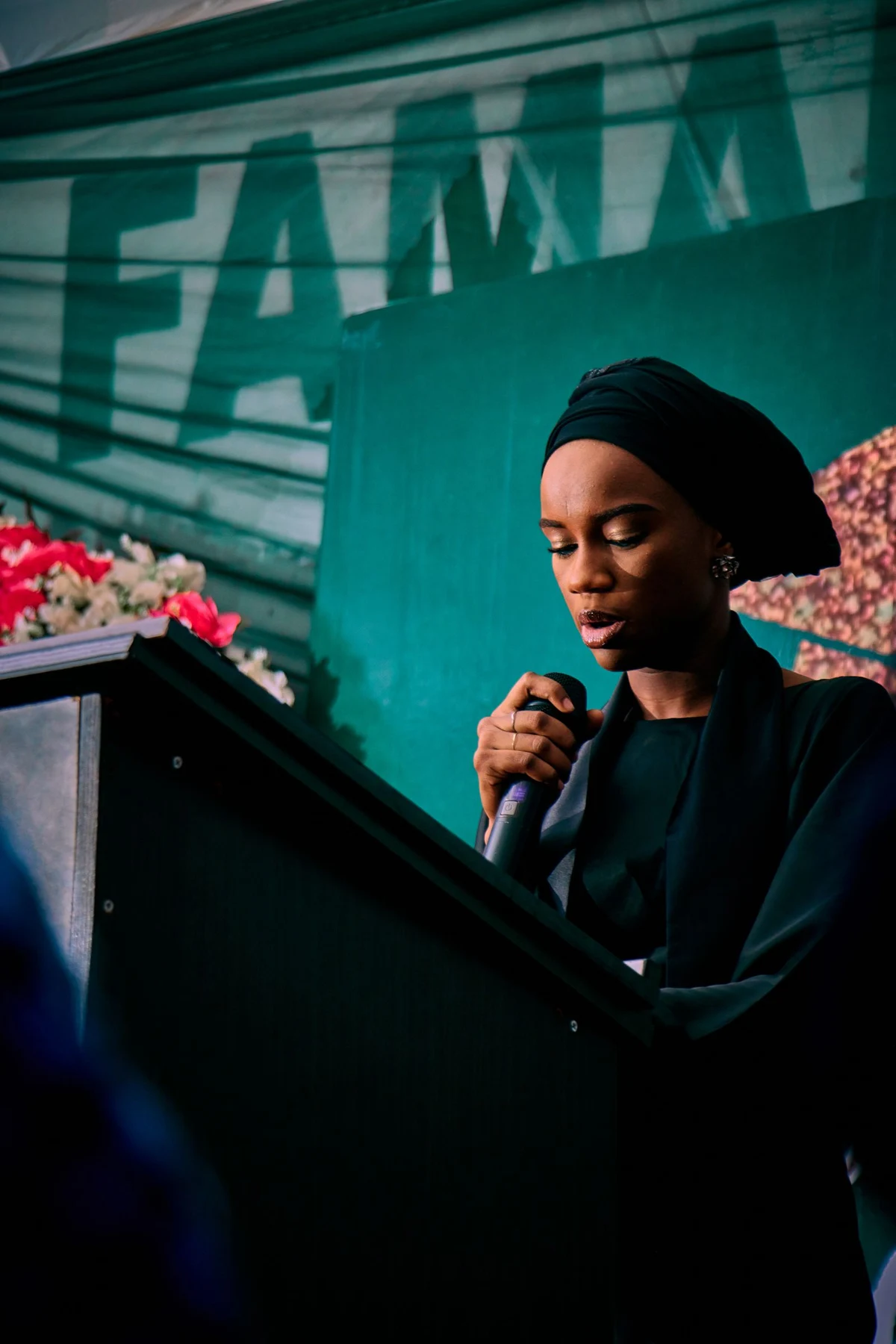 A woman speaking at a lectern during an event; illustrative stock photography